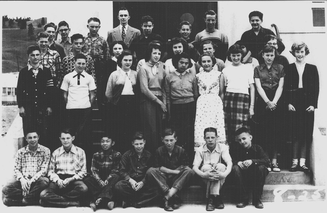 KHS Grade 8, Mr. Lennox  1952-53 - Top Row- Robert Walker, Pat Cowan, Jim Goodkey, Bill Lennox (Teacher), Gary Hogg, Ken Moyer, Ron Methot, Wilfred Durand.  3rd Row-Derrick Mitchell, Bill Hetzler, Wilma Ernewein, ?, Flora Braithwaite, Roma Holt, Sariann Mohammad Ali, Pat Davoren.  2nd Row-Nick Hajdukovich, Laron Smith, Shirley Abraham, Rena LaBlond, Susan Gottfriedson, Deanna Warsimage, Shirley Smith, Diane Pilling, Diane Gardiner.  1st Row-Brian White, Bob Goldie, George Nishimura, Fred Bagg, George Slack, John Henstock, Gerald Glowacki